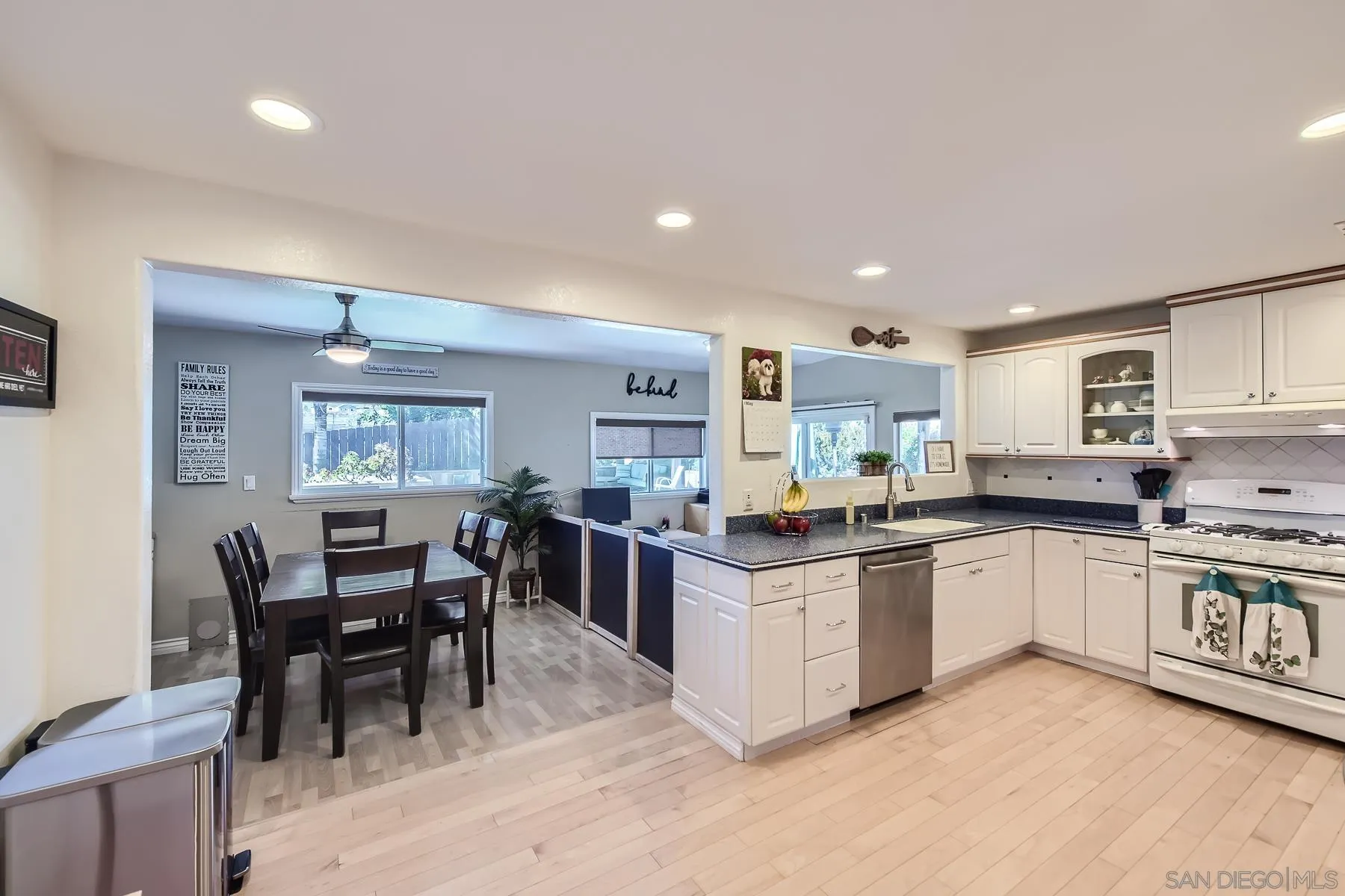 8510 Rumson Drive Santee, CA 92071 - Photo 12 of 26 a kitchen with stainless steel appliances kitchen island granite countertop a table chairs sink and cabinets