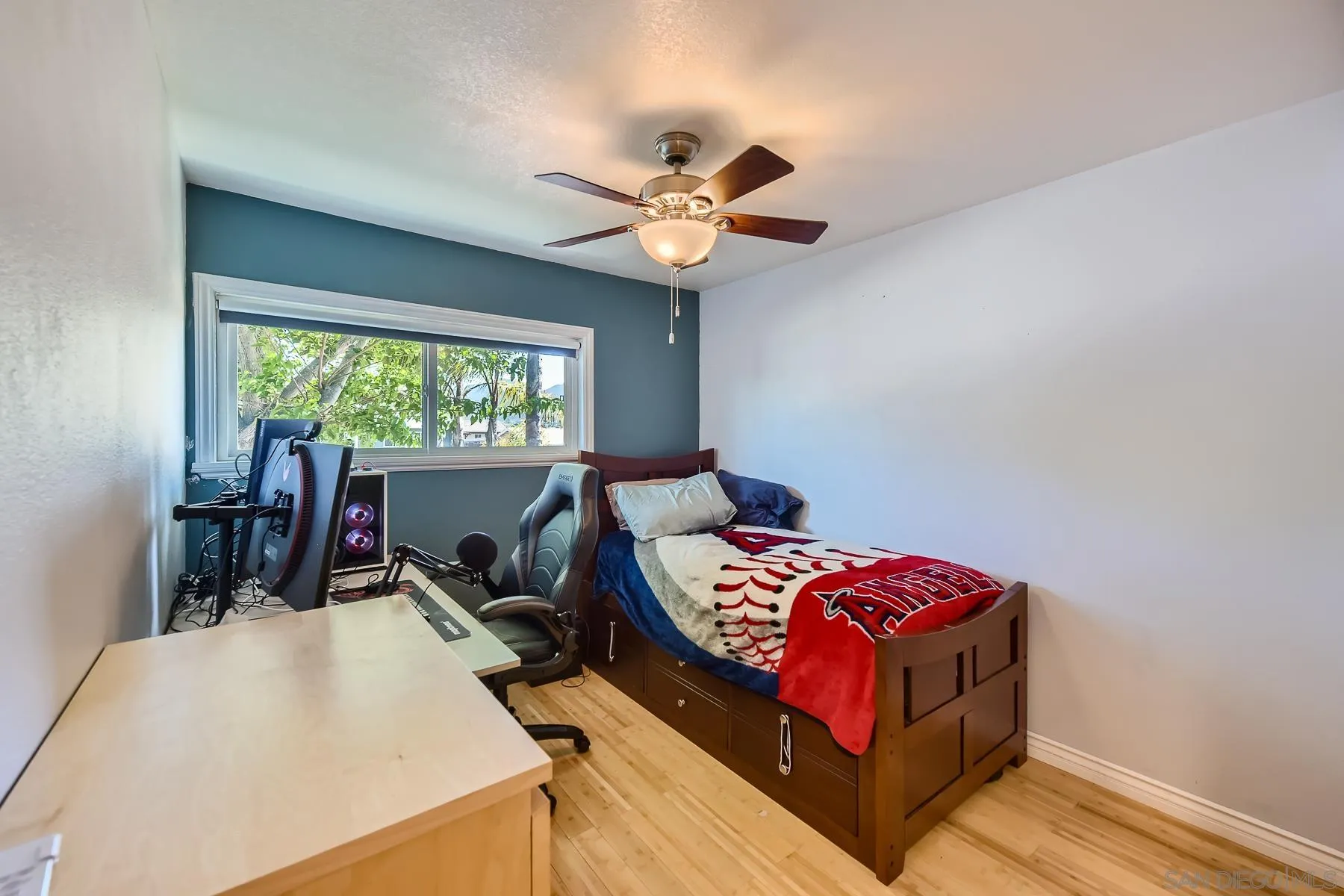 8510 Rumson Drive Santee, CA 92071 - Photo 19 of 26 a bedroom with a bed and a chandelier