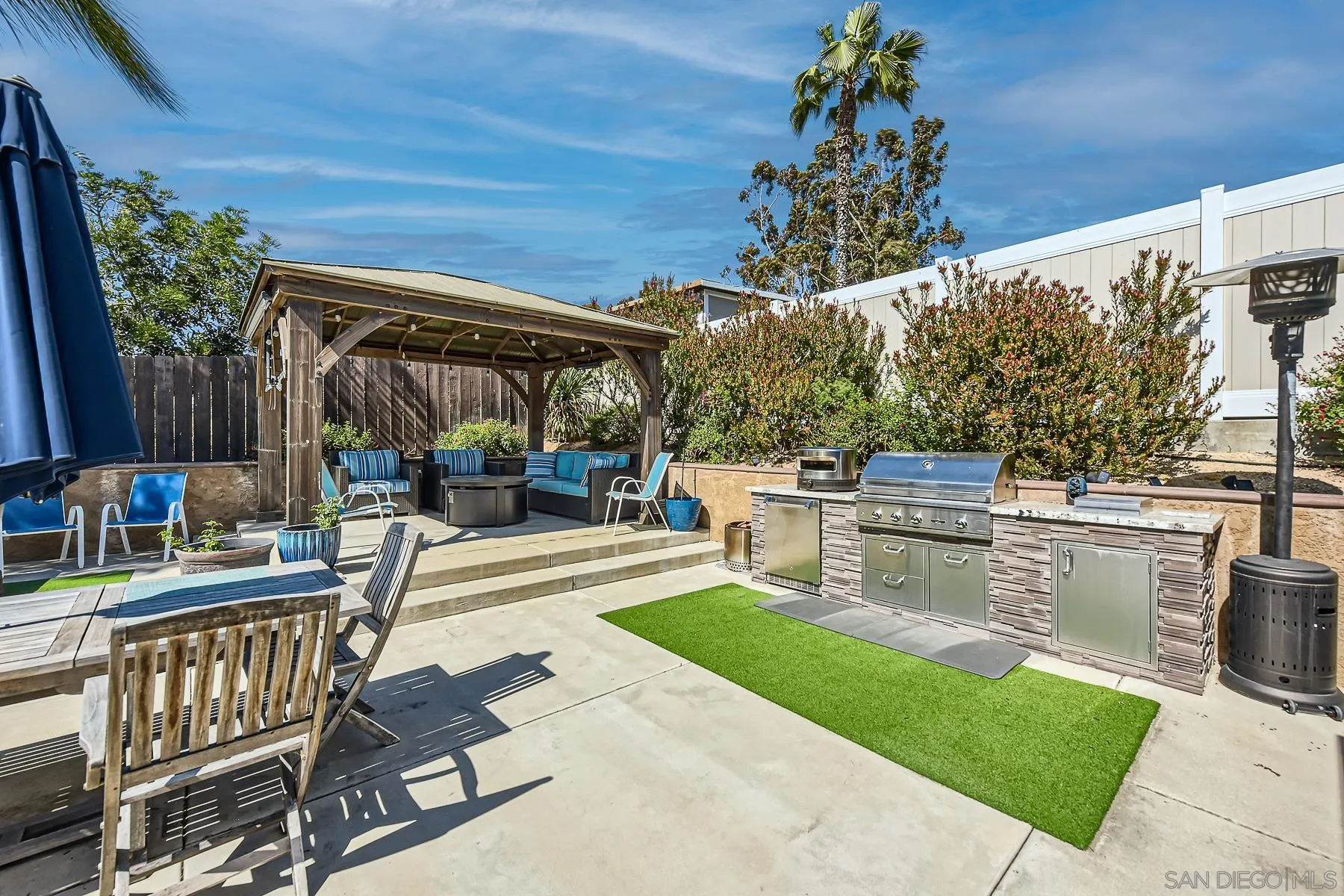 8510 Rumson Drive Santee, CA 92071 - Photo 5 of 26 a view of a patio with table and chairs potted plants with wooden floor and fence