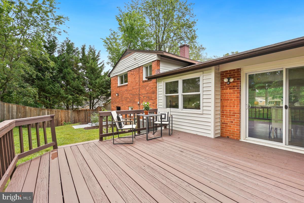 827 Caddington Avenue Silver Spring, MD 20901 - Photo 40 of 45 a view of a deck with chairs a barbeque with wooden floor and fence
