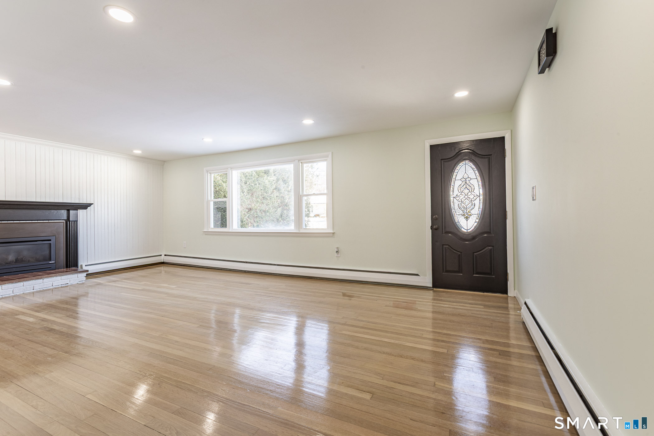 26 Kelly Road Hamden, CT 06518 - Photo 8 of 37 an empty room with wooden floor and windows