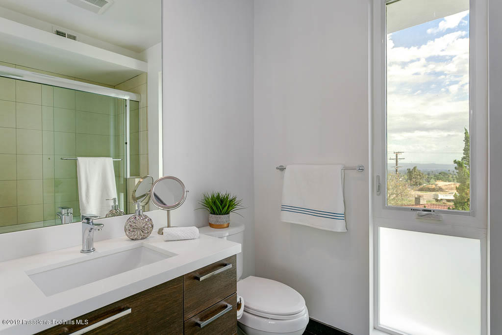 319 Camillo Road Sierra Madre, CA 91024 - Photo 32 of 40 a bathroom with a granite countertop sink toilet and mirror