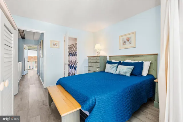 a bedroom with a bed and a wooden floor