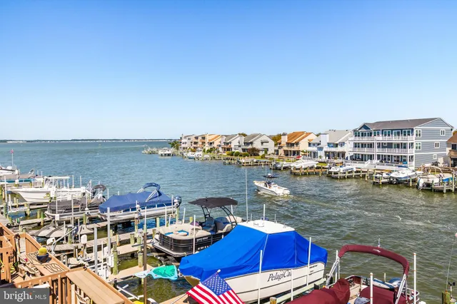 a view of a lake with a table and chairs
