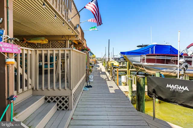 an aerial view of ocean and residential houses with outdoor space