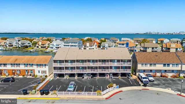 an aerial view of a house with a garden and lake view
