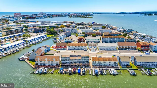 a view of a lake with a table and chairs