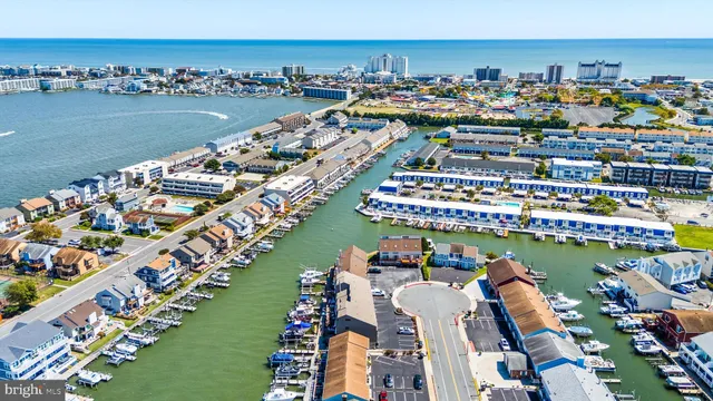 an aerial view of a swimming pool and outdoor seating
