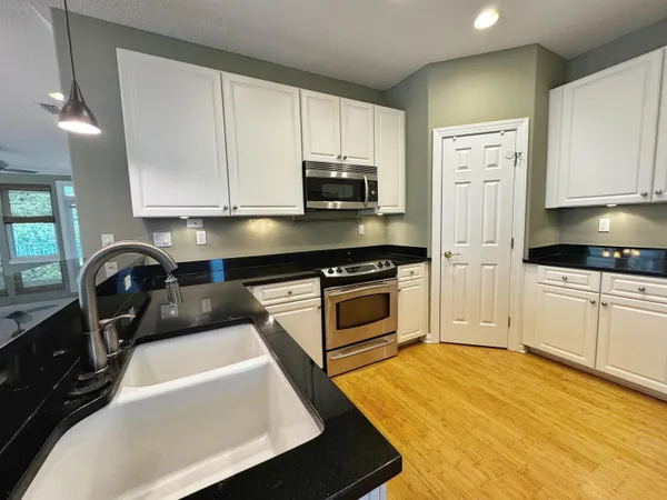 a kitchen with a sink a stove and refrigerator