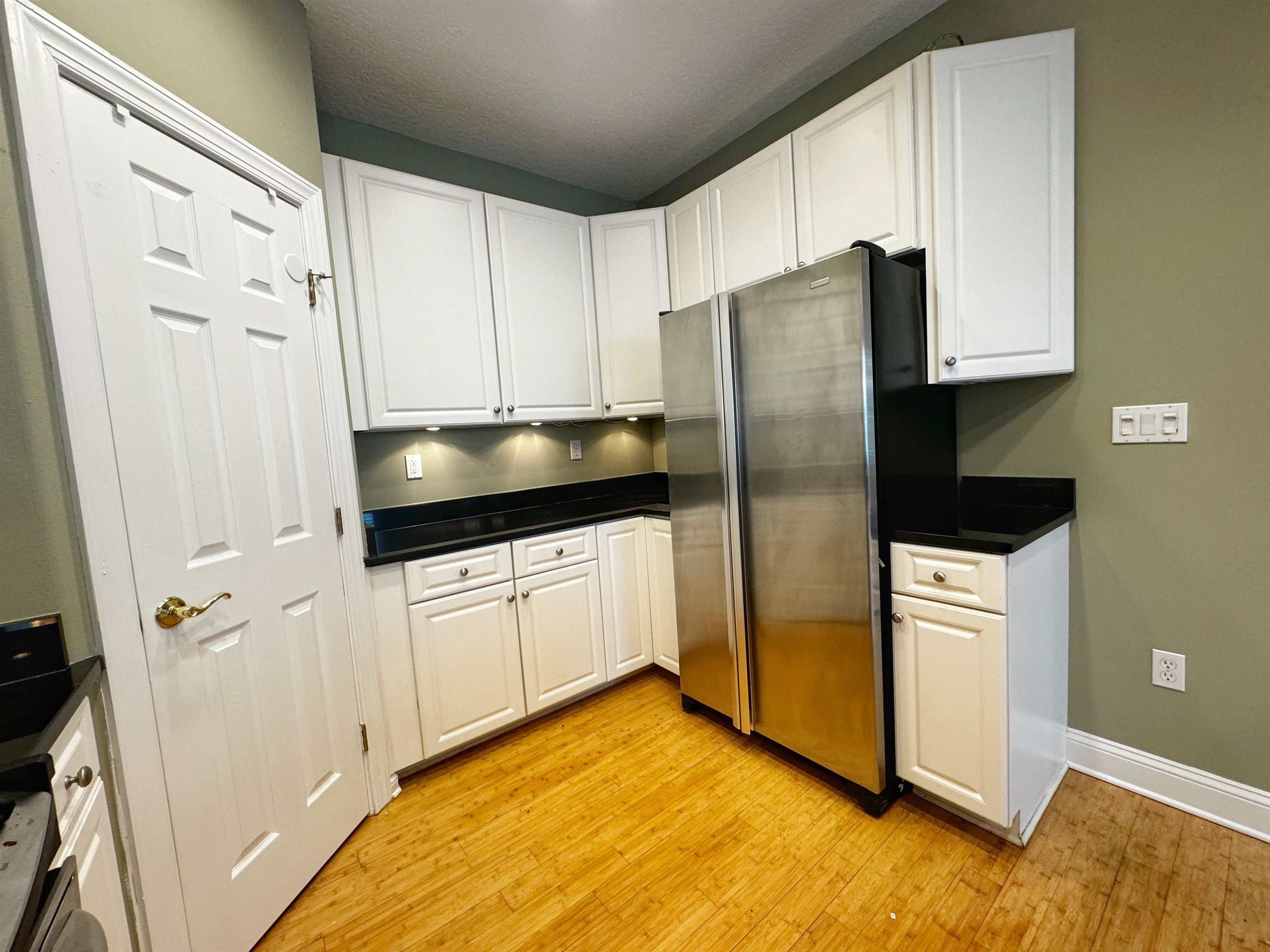 113 Sunset Circle South St. Augustine, FL 32080 - Photo 12 of 33 a kitchen with a refrigerator sink and cabinets