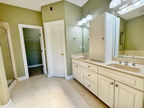 a spacious bathroom with a mirror sink and shower