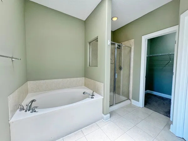 a spacious bathroom with a bathtub and a shower