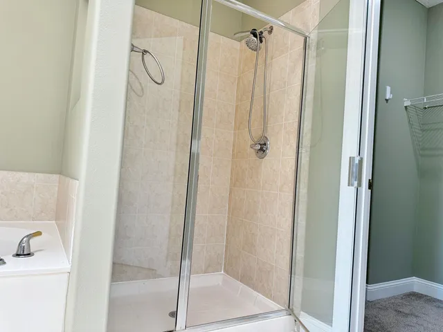 a bathroom with a shower and a sink