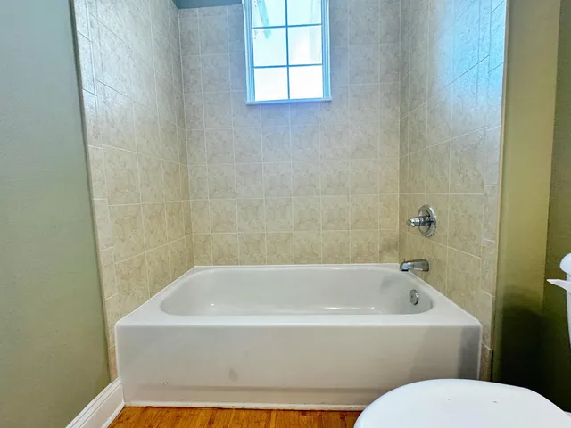 a white bath tub sitting next to a white toilet