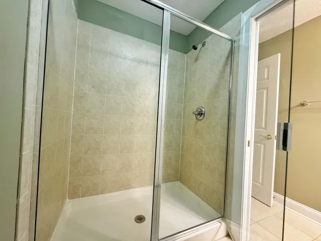 a bathroom with a glass shower door