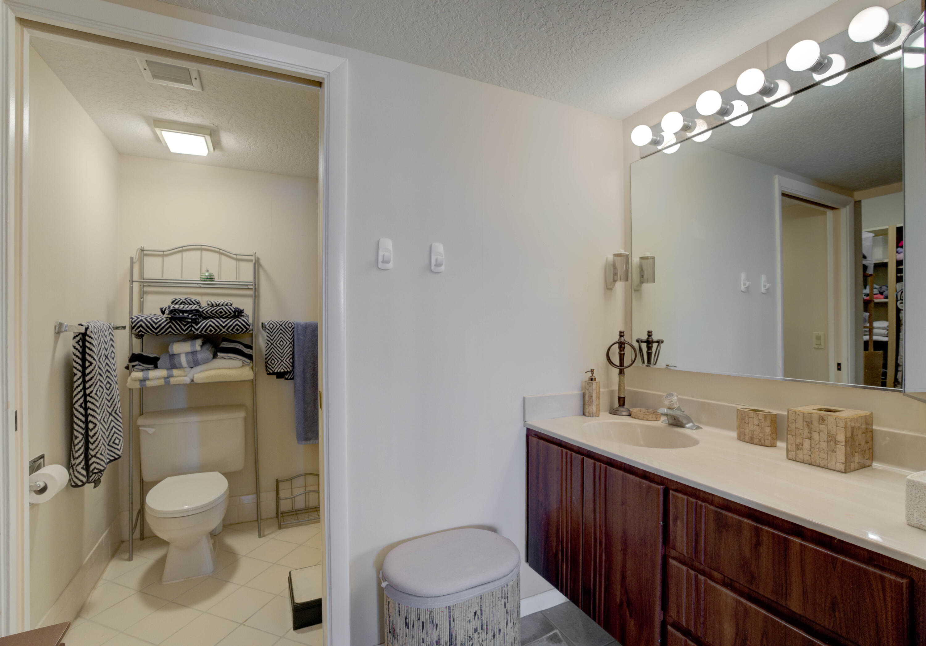 801 Seafarer Circle, Unit 404 Jupiter, FL 33477 - Photo 13 of 34 a bathroom with a toilet a sink and mirror