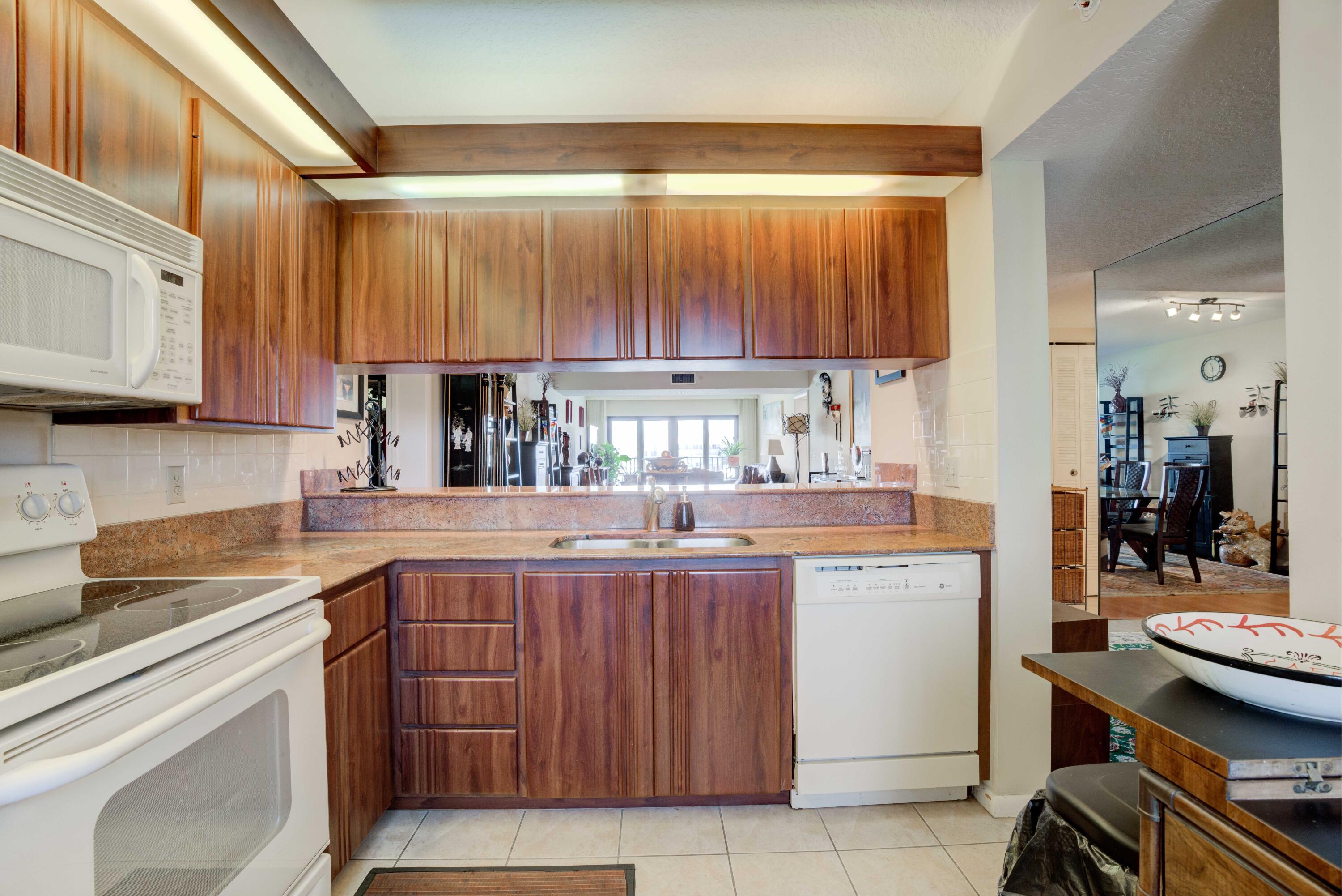 801 Seafarer Circle, Unit 404 Jupiter, FL 33477 - Photo 14 of 34 a kitchen with a sink and cabinets