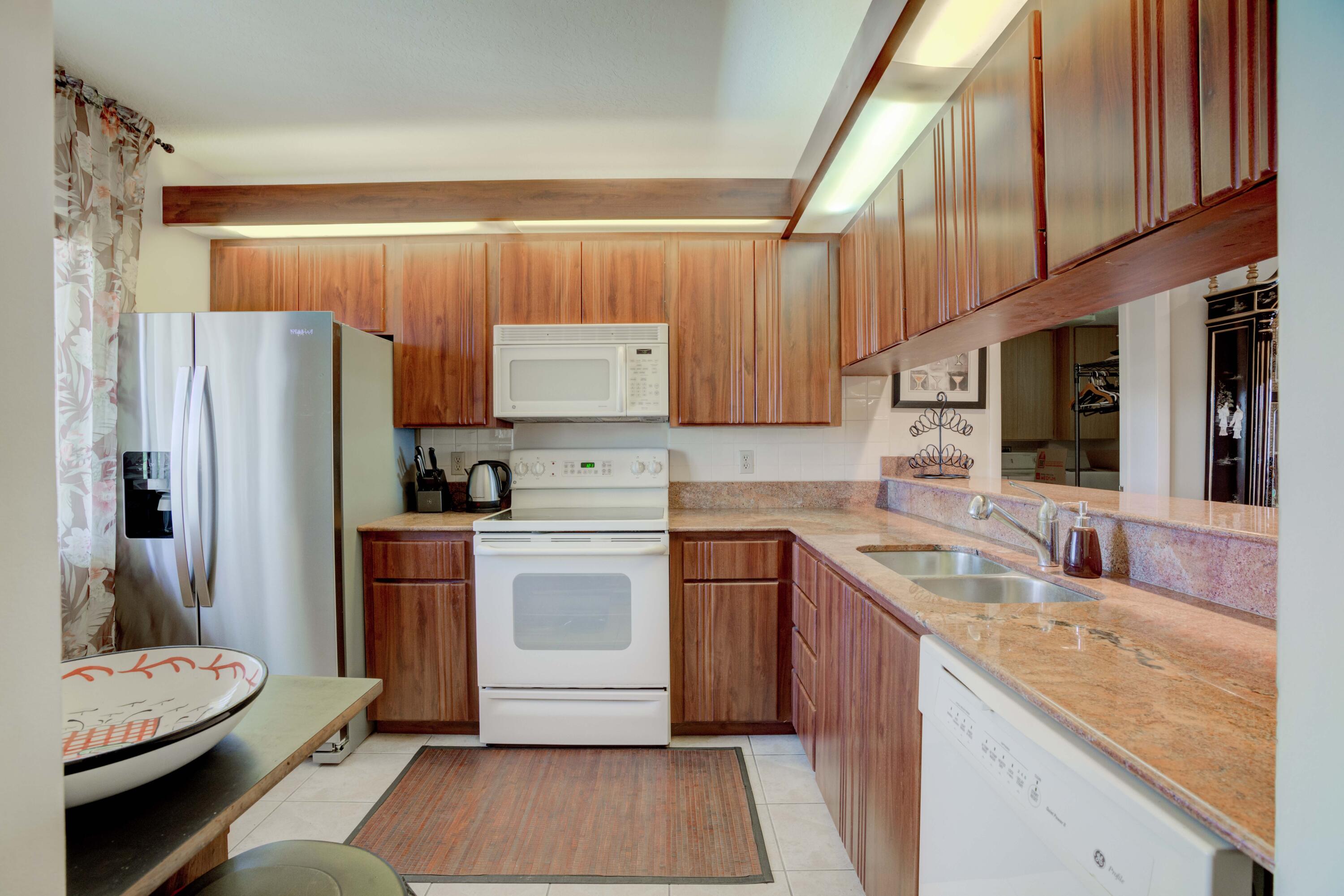 801 Seafarer Circle, Unit 404 Jupiter, FL 33477 - Photo 16 of 34 a kitchen with a sink stove and refrigerator