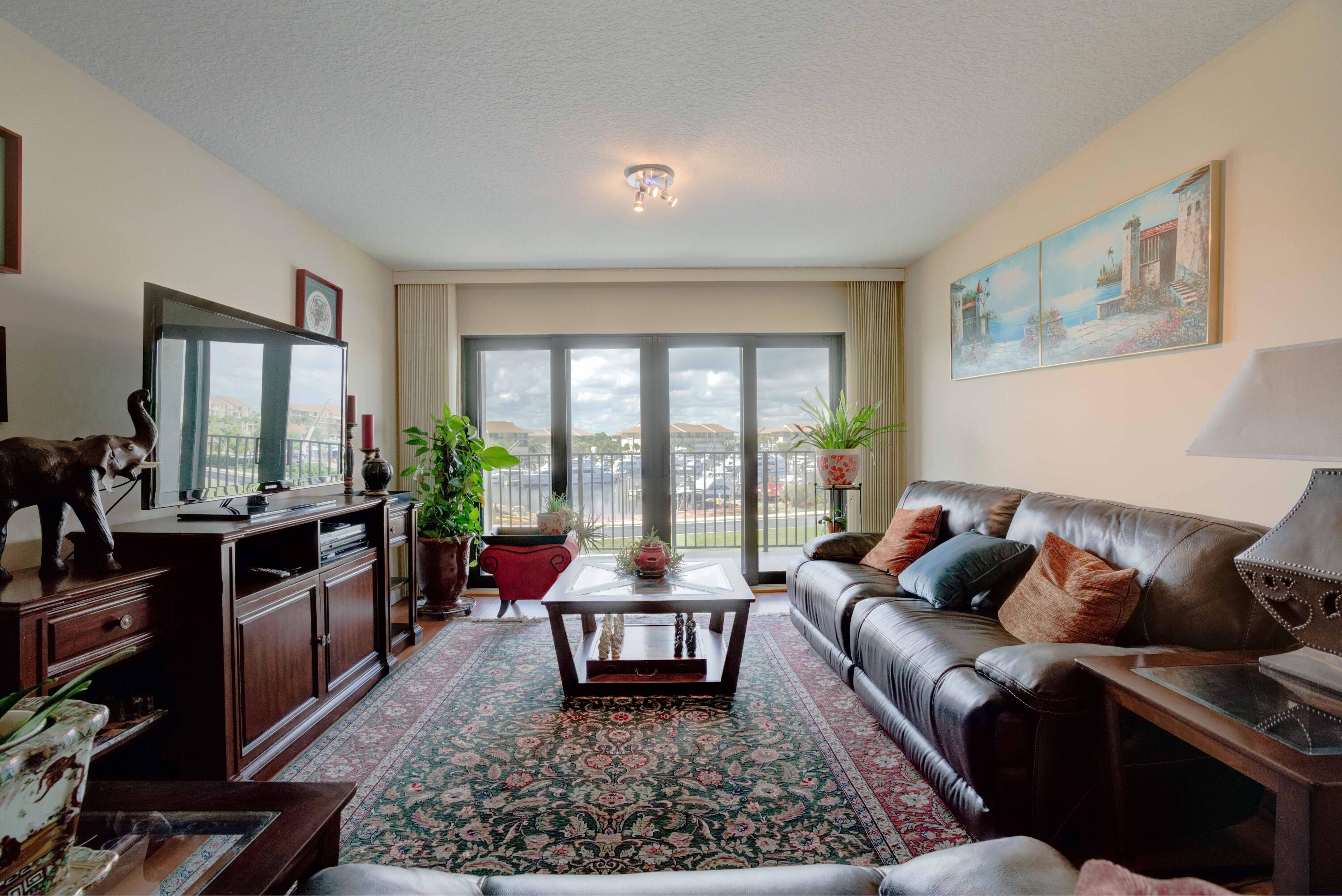 801 Seafarer Circle, Unit 404 Jupiter, FL 33477 - Photo 23 of 34 a living room with furniture and a large window