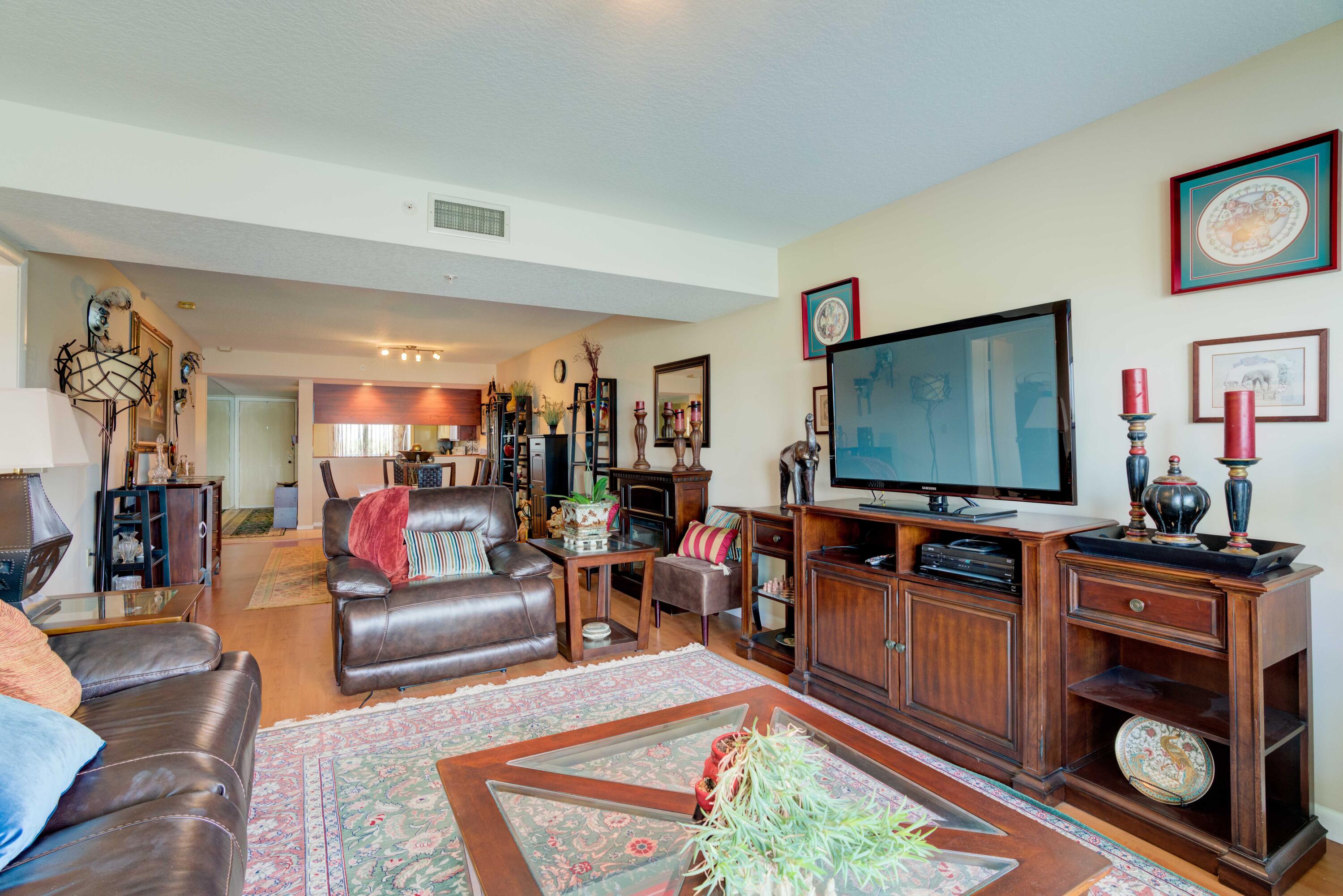 801 Seafarer Circle, Unit 404 Jupiter, FL 33477 - Photo 26 of 34 a living room with furniture and a flat screen tv
