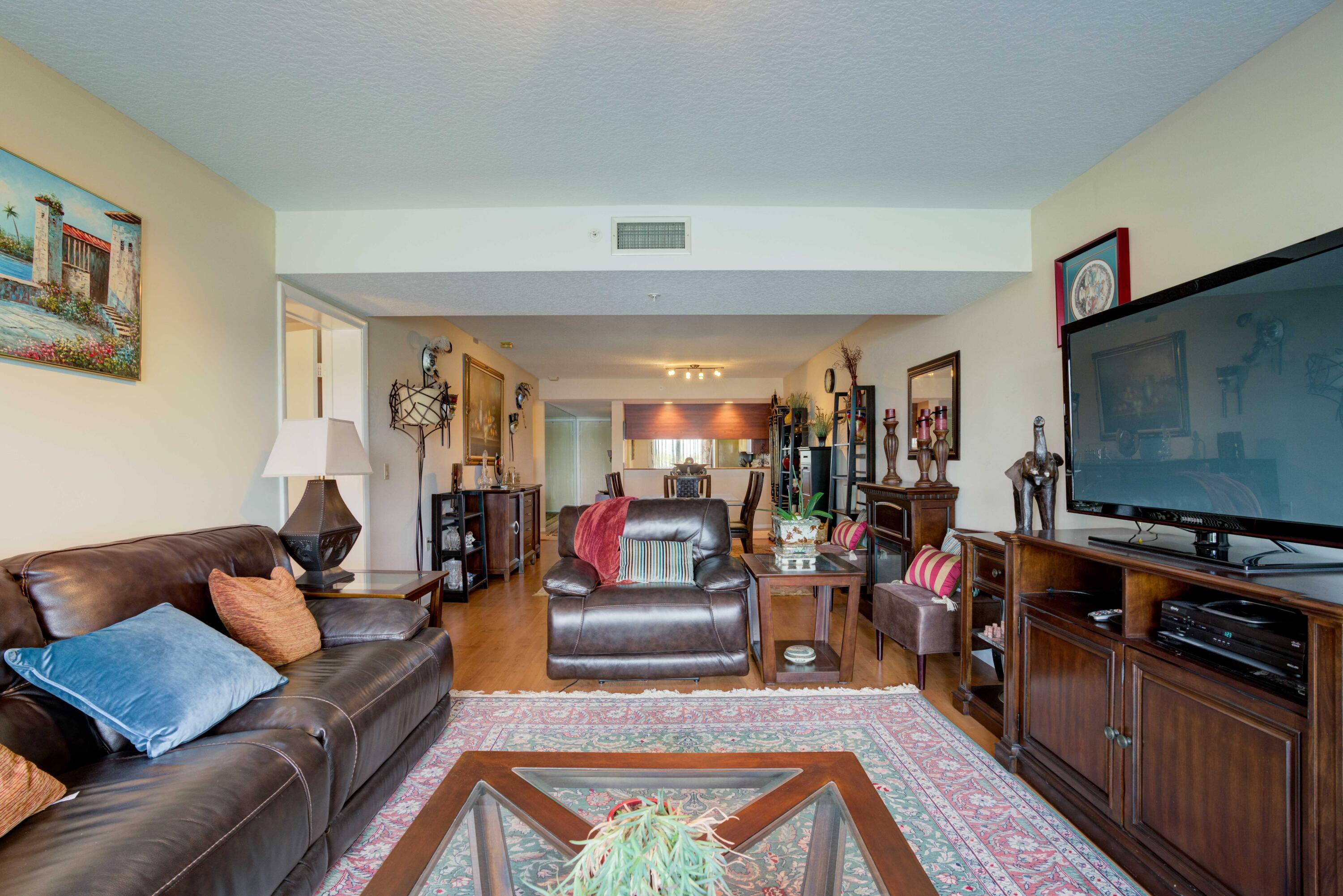 801 Seafarer Circle, Unit 404 Jupiter, FL 33477 - Photo 27 of 34 a living room with furniture and a flat screen tv