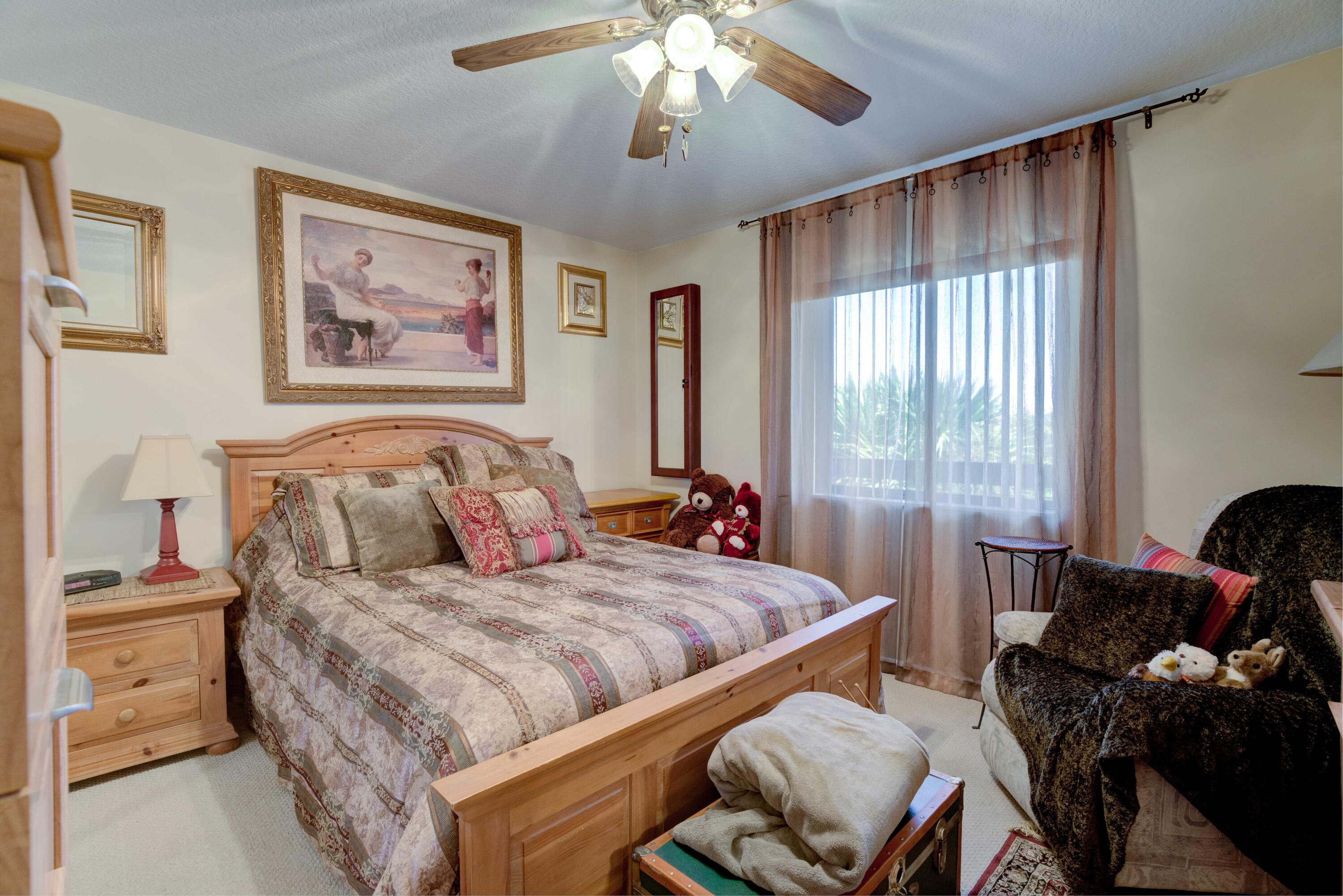 801 Seafarer Circle, Unit 404 Jupiter, FL 33477 - Photo 29 of 34 a bedroom with furniture and a large window