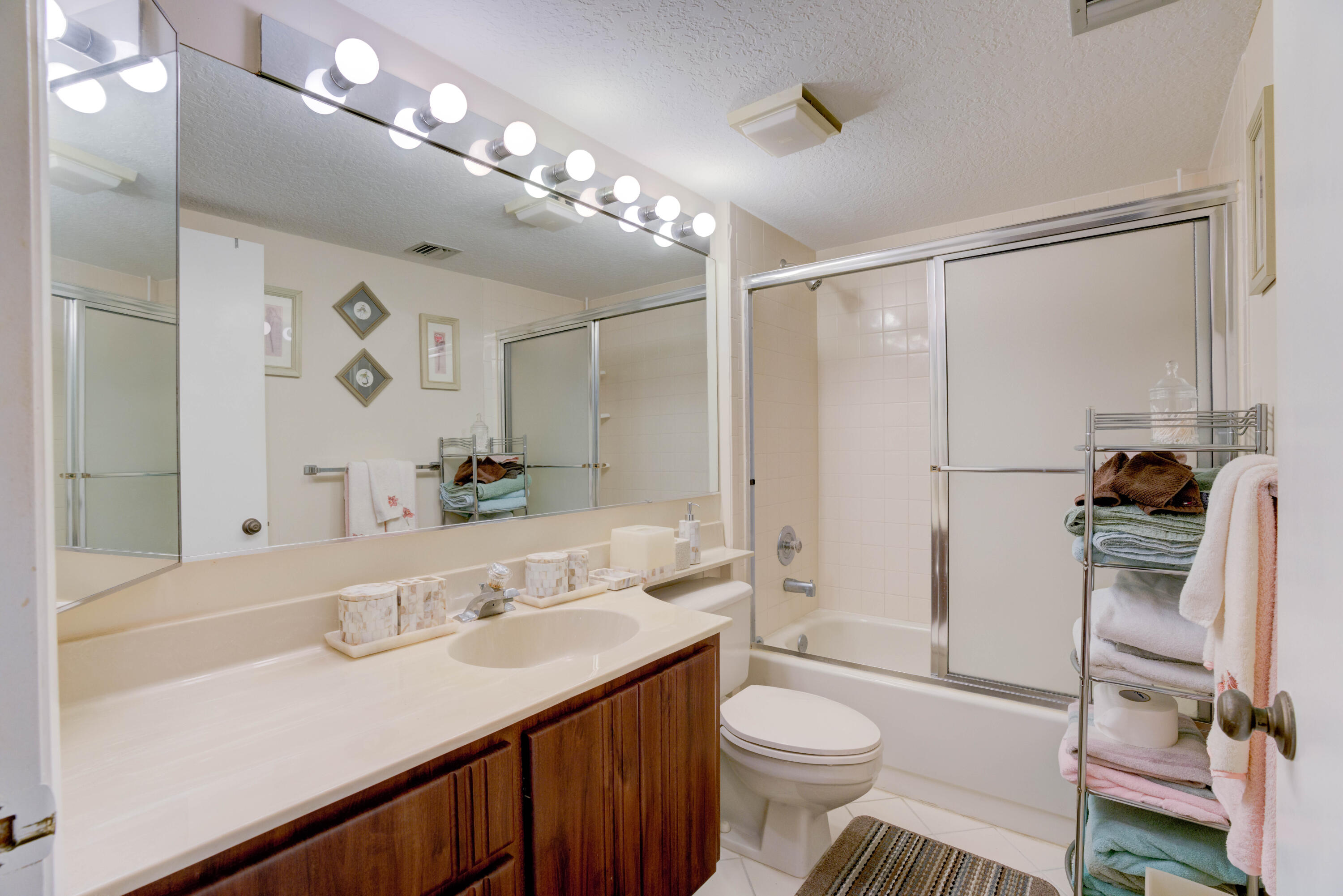 801 Seafarer Circle, Unit 404 Jupiter, FL 33477 - Photo 30 of 34 a bathroom with a sink a toilet a mirror and shower
