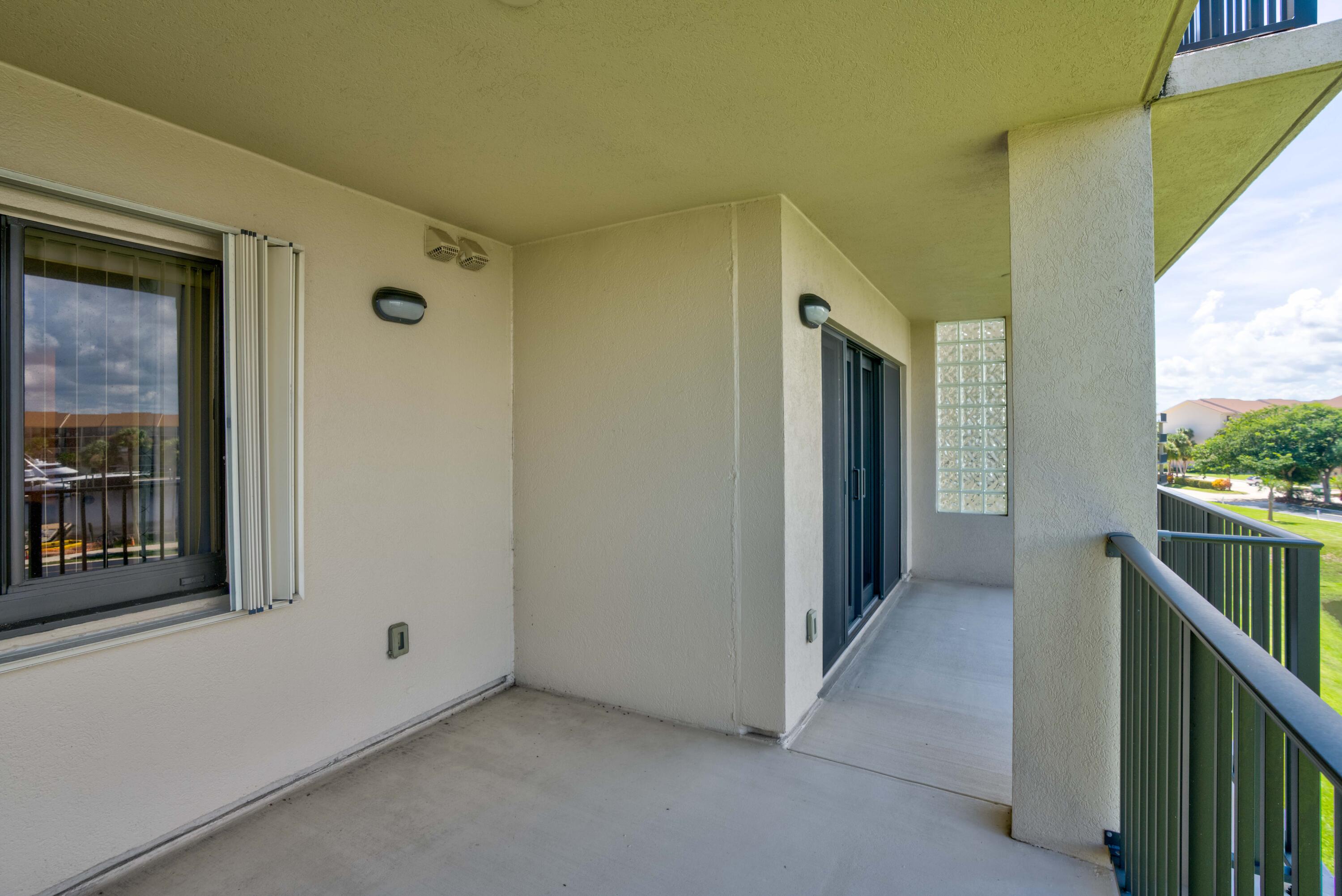 801 Seafarer Circle, Unit 404 Jupiter, FL 33477 - Photo 6 of 34 a view of hallway with a window and stairs