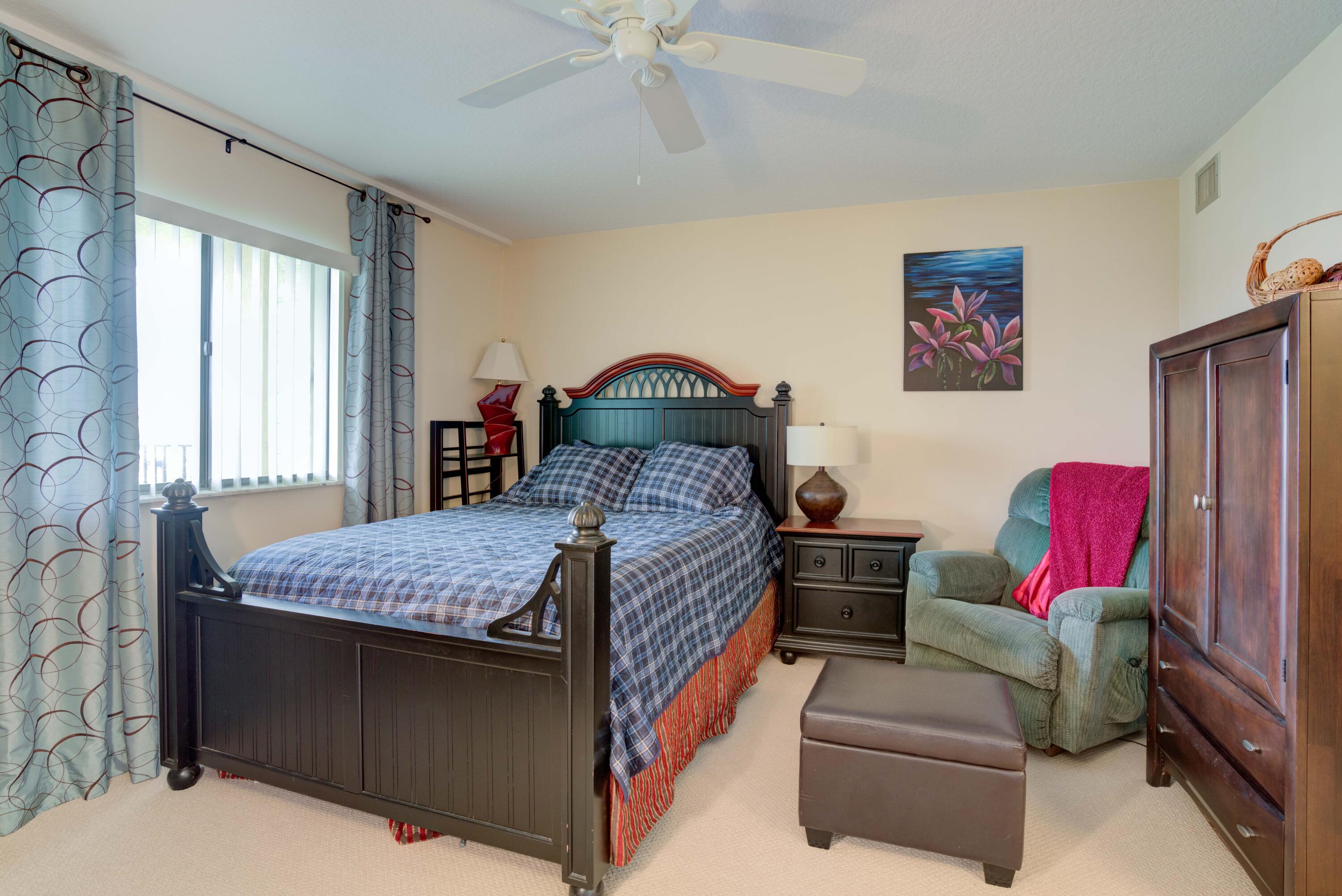 801 Seafarer Circle, Unit 404 Jupiter, FL 33477 - Photo 8 of 34 a bedroom with bed and a window