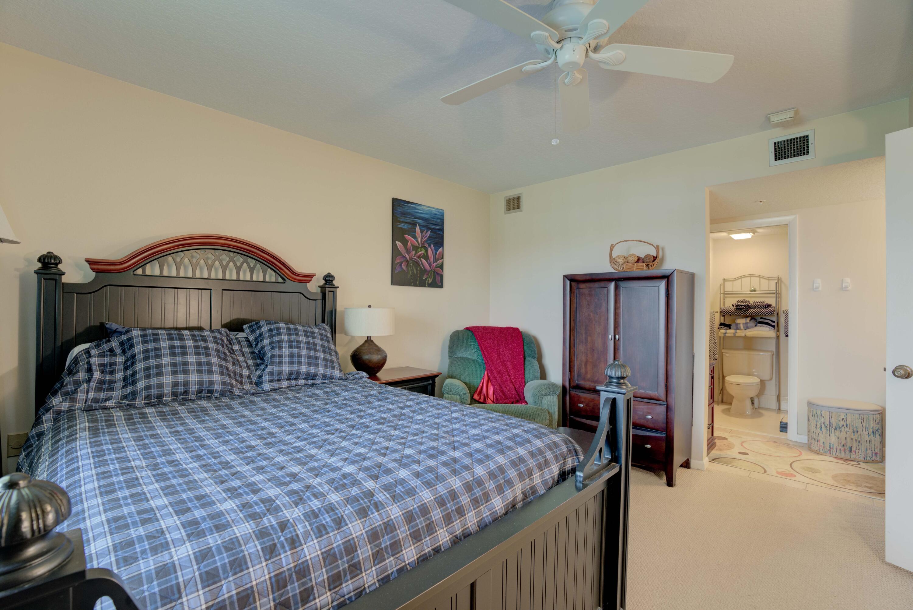 801 Seafarer Circle, Unit 404 Jupiter, FL 33477 - Photo 9 of 34 a bedroom with a bed and dresser