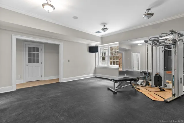 a view of a livingroom with workspace and a window