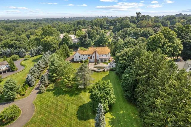 an aerial view of a house with a yard