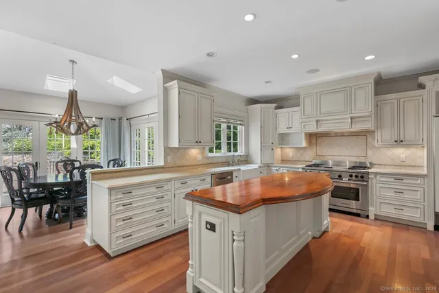 a kitchen with stainless steel appliances granite countertop a stove and a sink