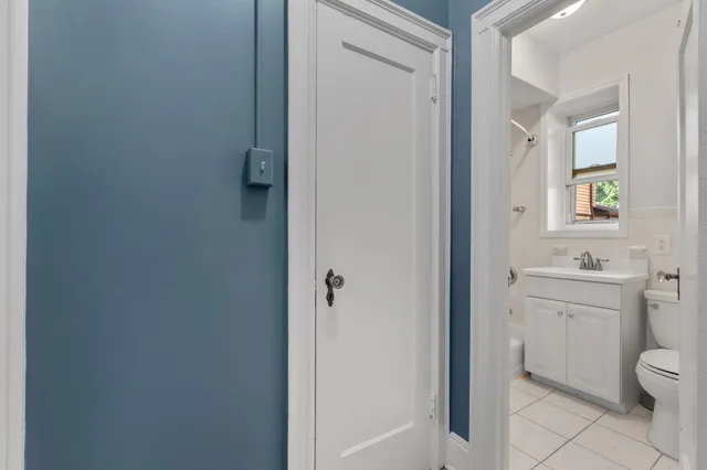 a bathroom with a granite countertop toilet a sink and a mirror