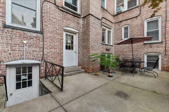 a backyard of a house with outdoor seating