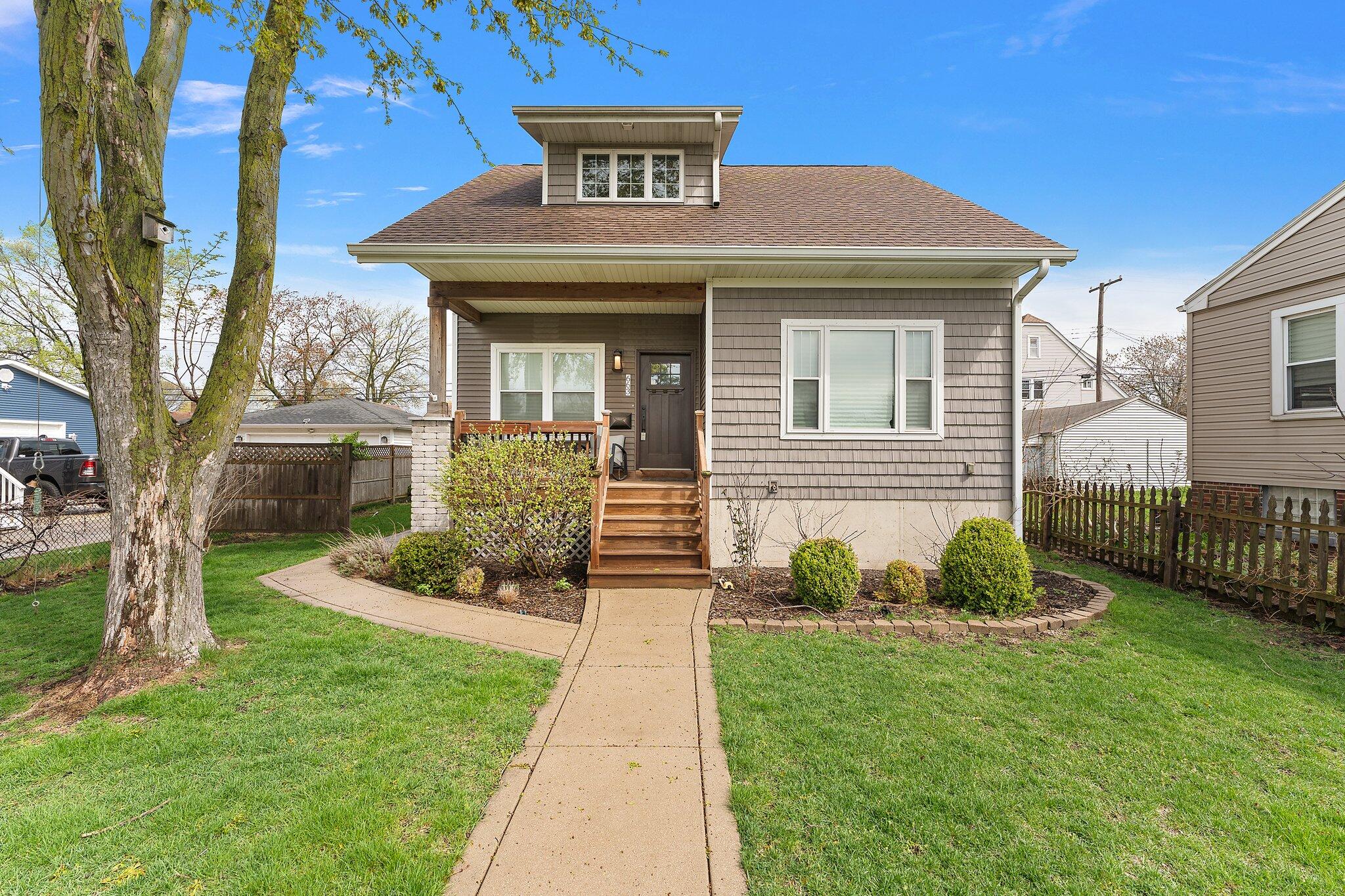 Undisclosed Address Whiting, IN 46394 - Photo 1 of 21 a front view of a house with garden