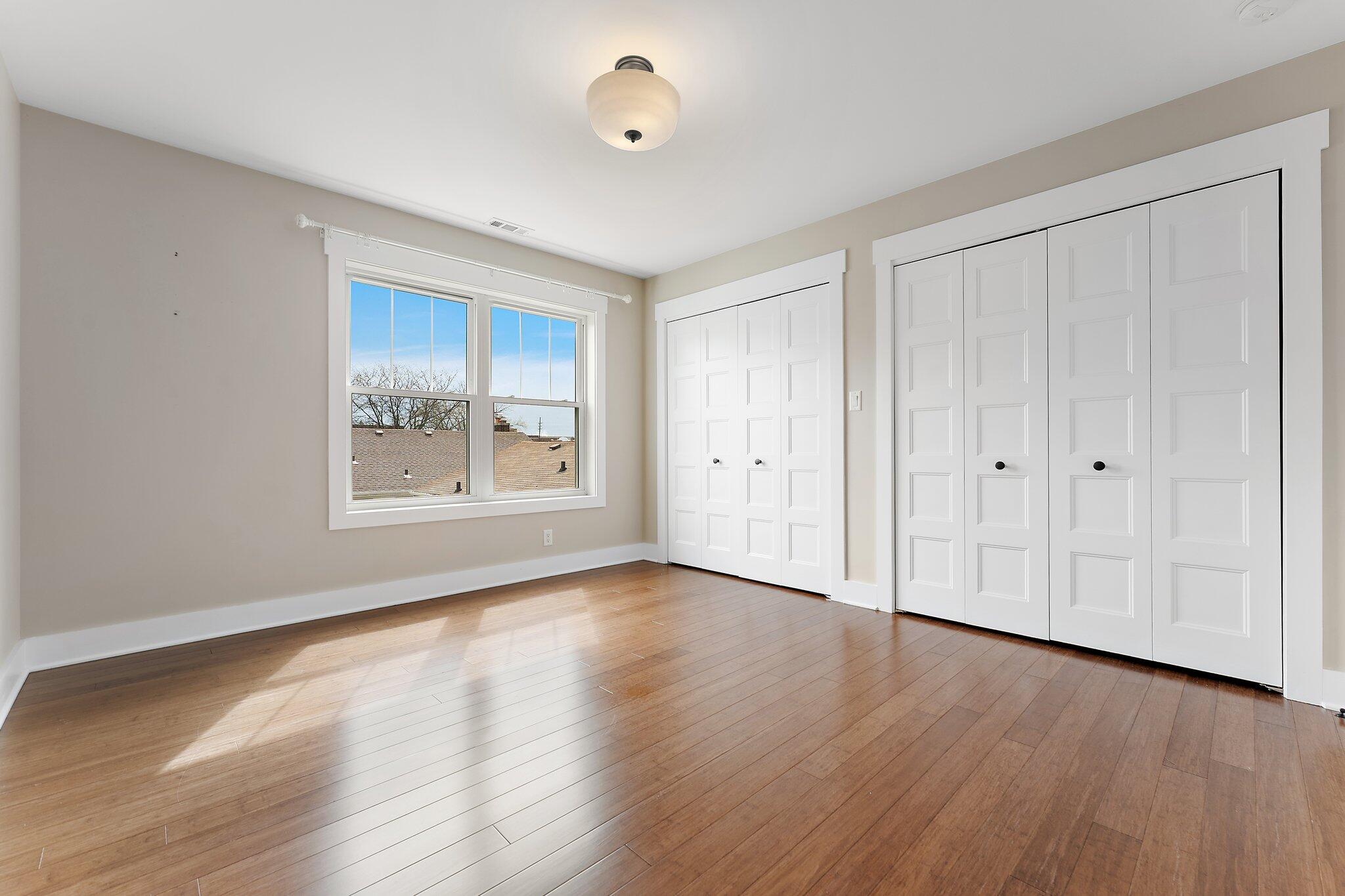 Undisclosed Address Whiting, IN 46394 - Photo 11 of 21 a view of an empty room with wooden floor and a window