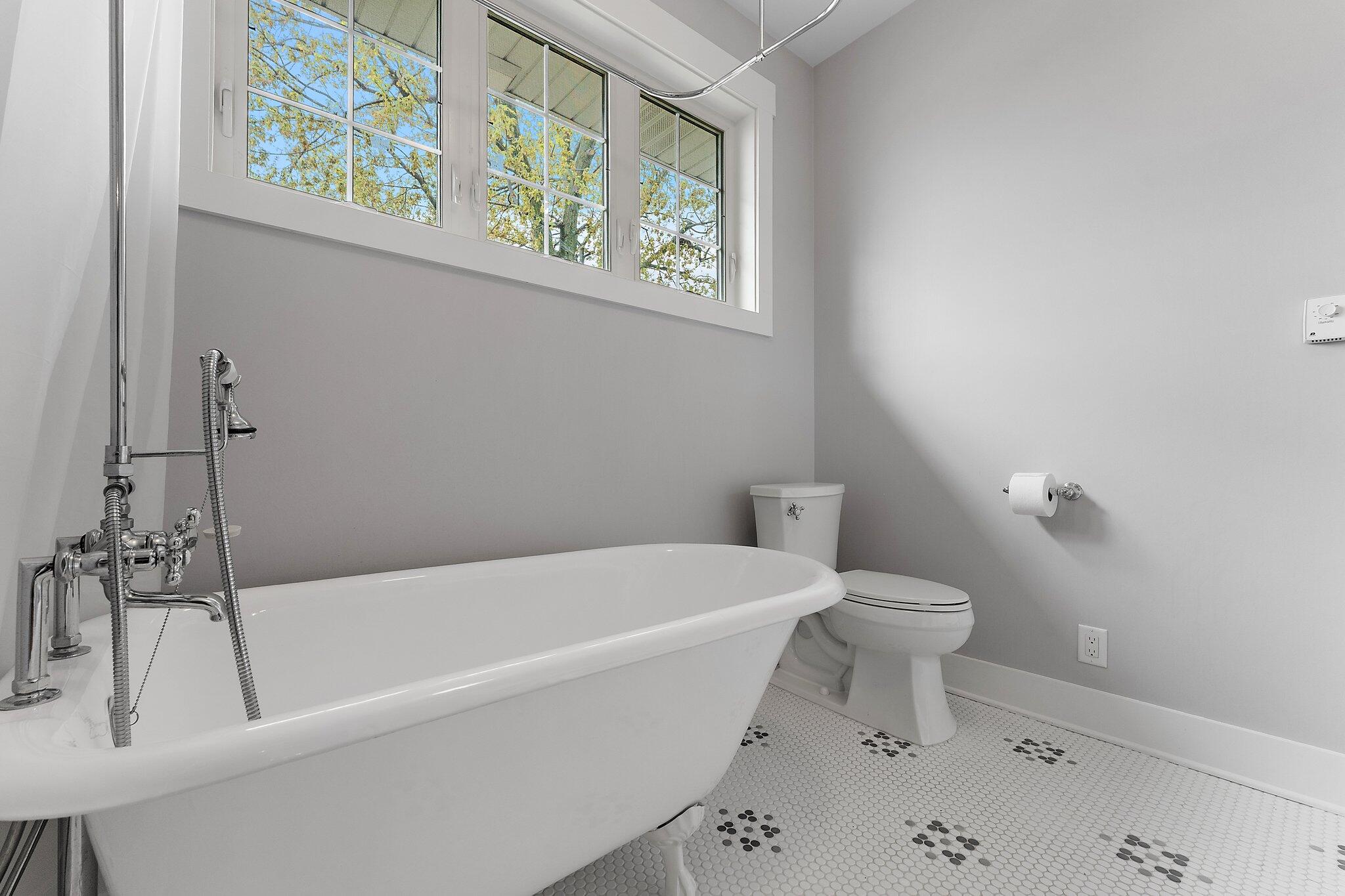 Undisclosed Address Whiting, IN 46394 - Photo 14 of 21 a white bath tub sitting next to a white toilet