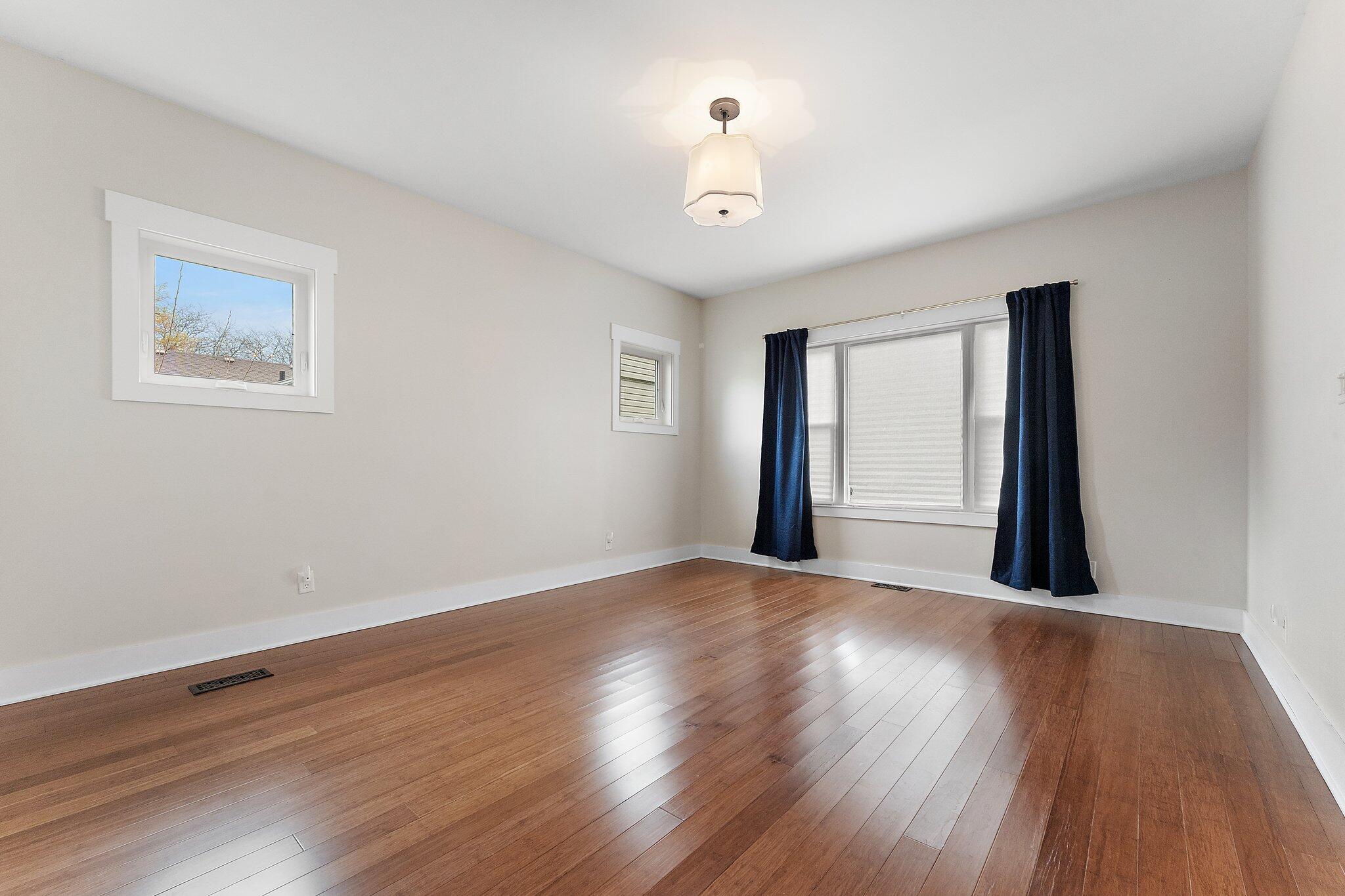 Undisclosed Address Whiting, IN 46394 - Photo 15 of 21 a view of an empty room with wooden floor and a window