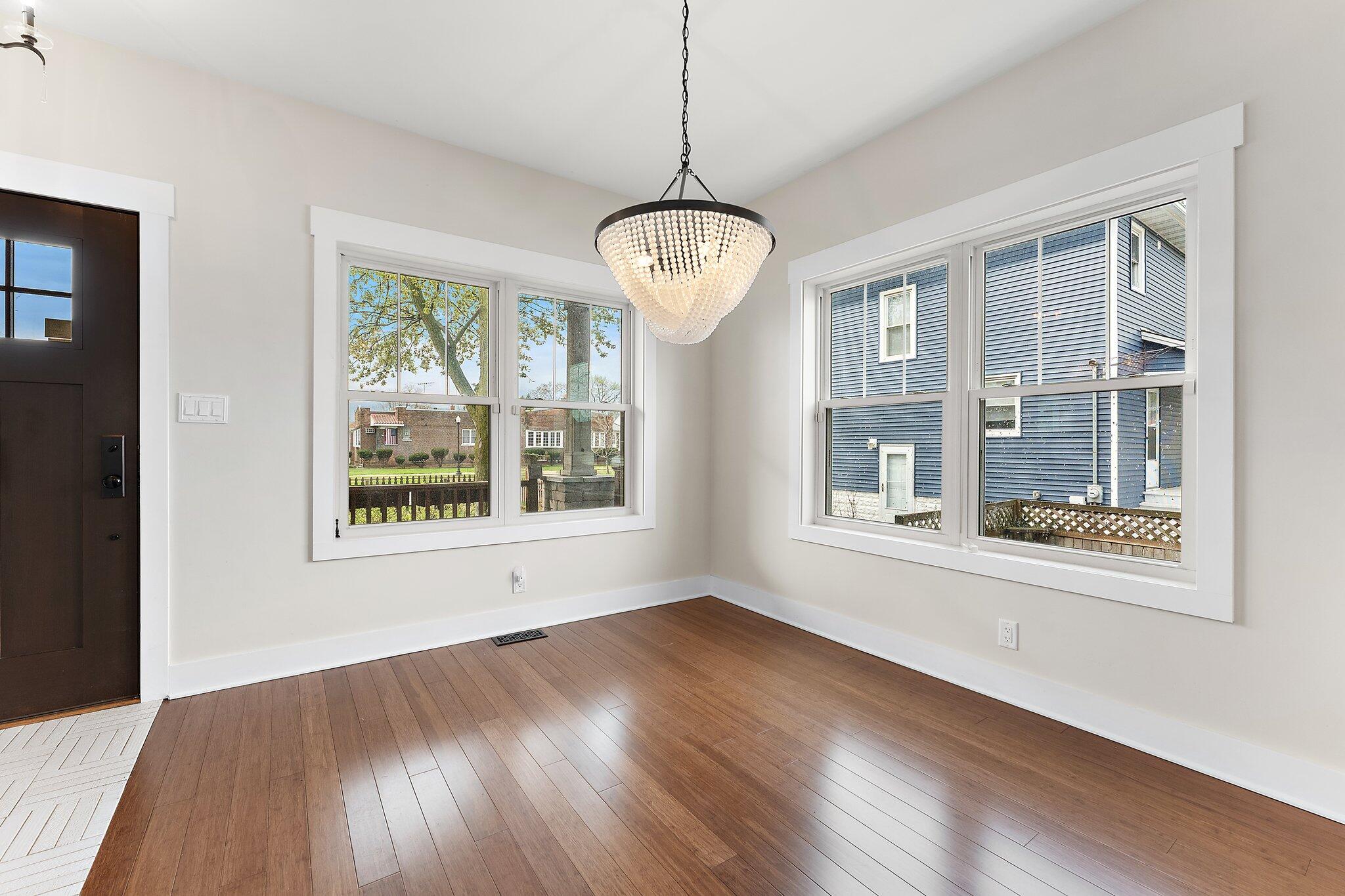 Undisclosed Address Whiting, IN 46394 - Photo 7 of 21 a view of an empty room with wooden floor and a window