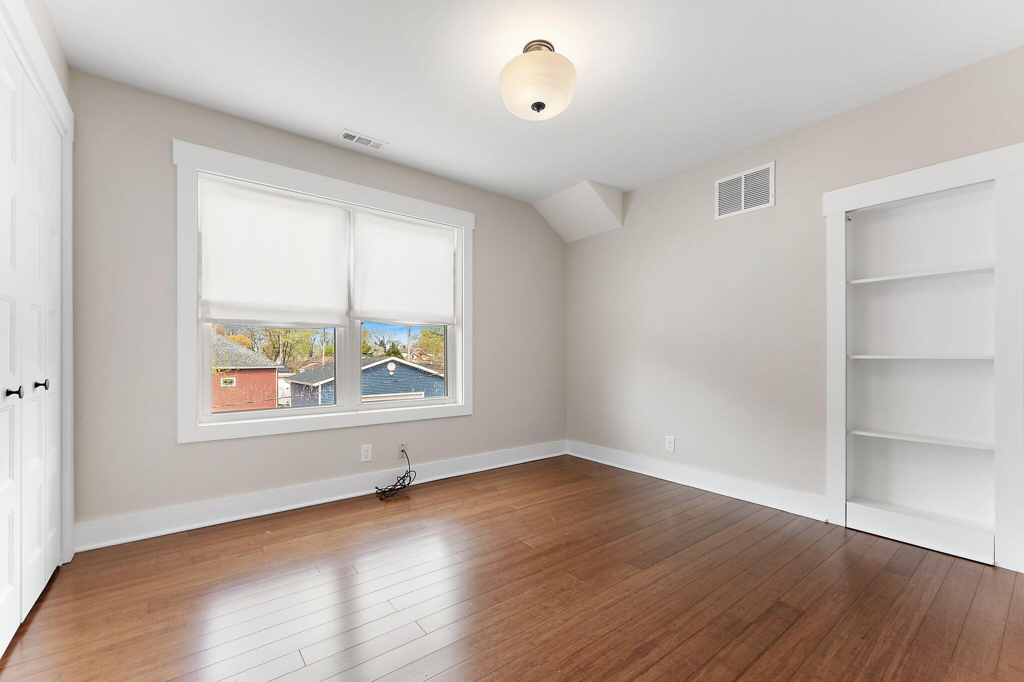 Undisclosed Address Whiting, IN 46394 - Photo 9 of 21 an empty room with wooden floor and windows