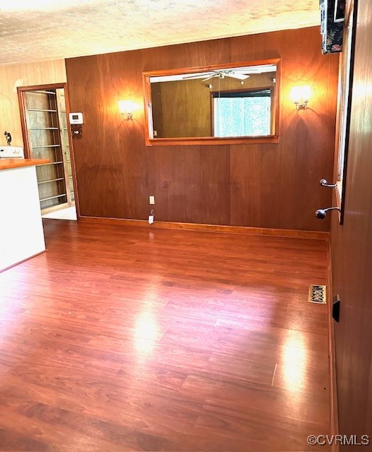 5216 Hemlock Road Quinton, VA 23141 - Photo 3 of 21 Empty room with wood finished floors, wood walls,