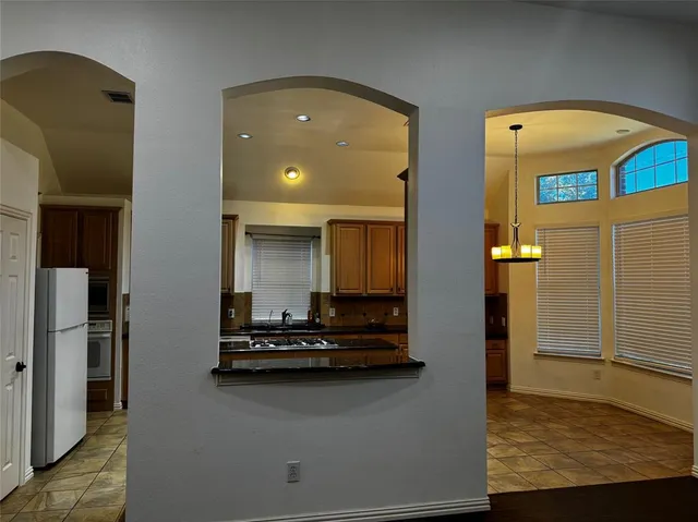 a bathroom with a sink double vanity granite and a bathtub