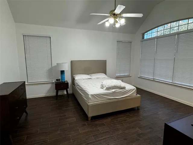 a living room with couches a flat screen tv and kitchen view
