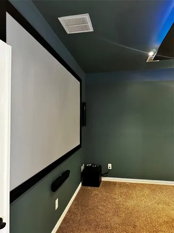 a view of a dining room with a table and chairs