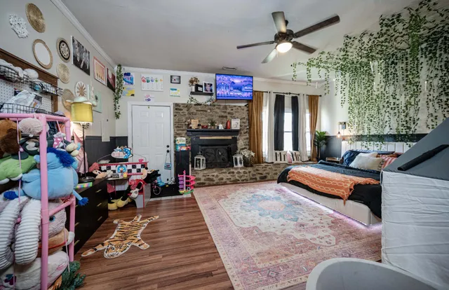 a bedroom with furniture and a fireplace