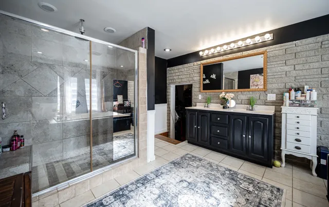 a spacious bathroom with a sink and a large mirror