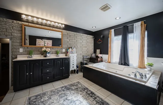 a spacious bathroom with a double vanity sink and a mirror
