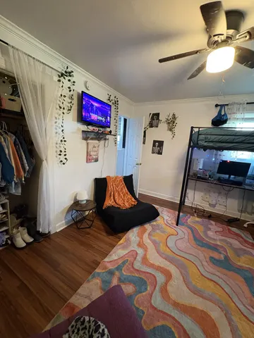 a bedroom with a bed and flat screen tv
