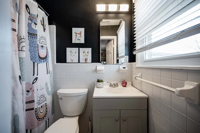 a bathroom with a toilet sink and mirror